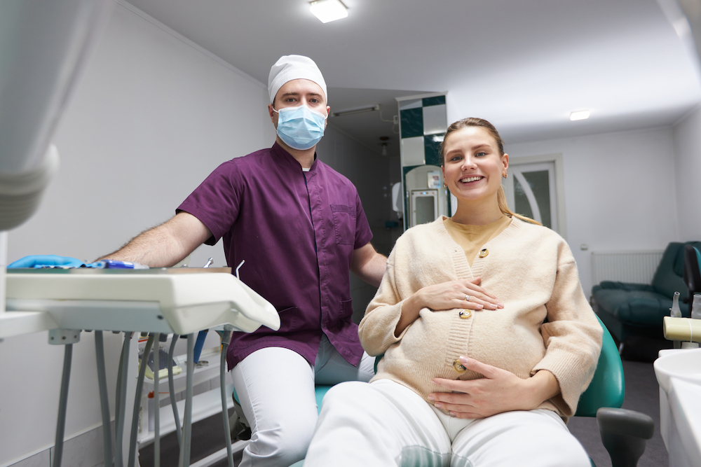 dentist doctor and pregnant woman smiling looking 2023 02 24 16 02 01 utc 1